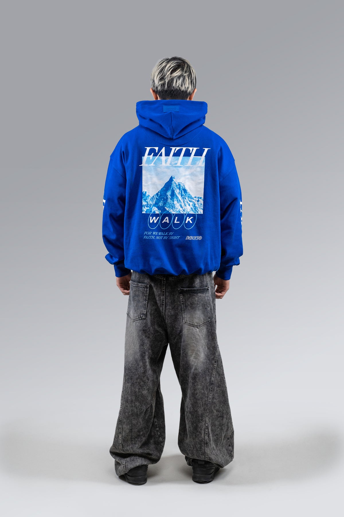 Male model wearing Blue Faith Walk Hoodie, back view