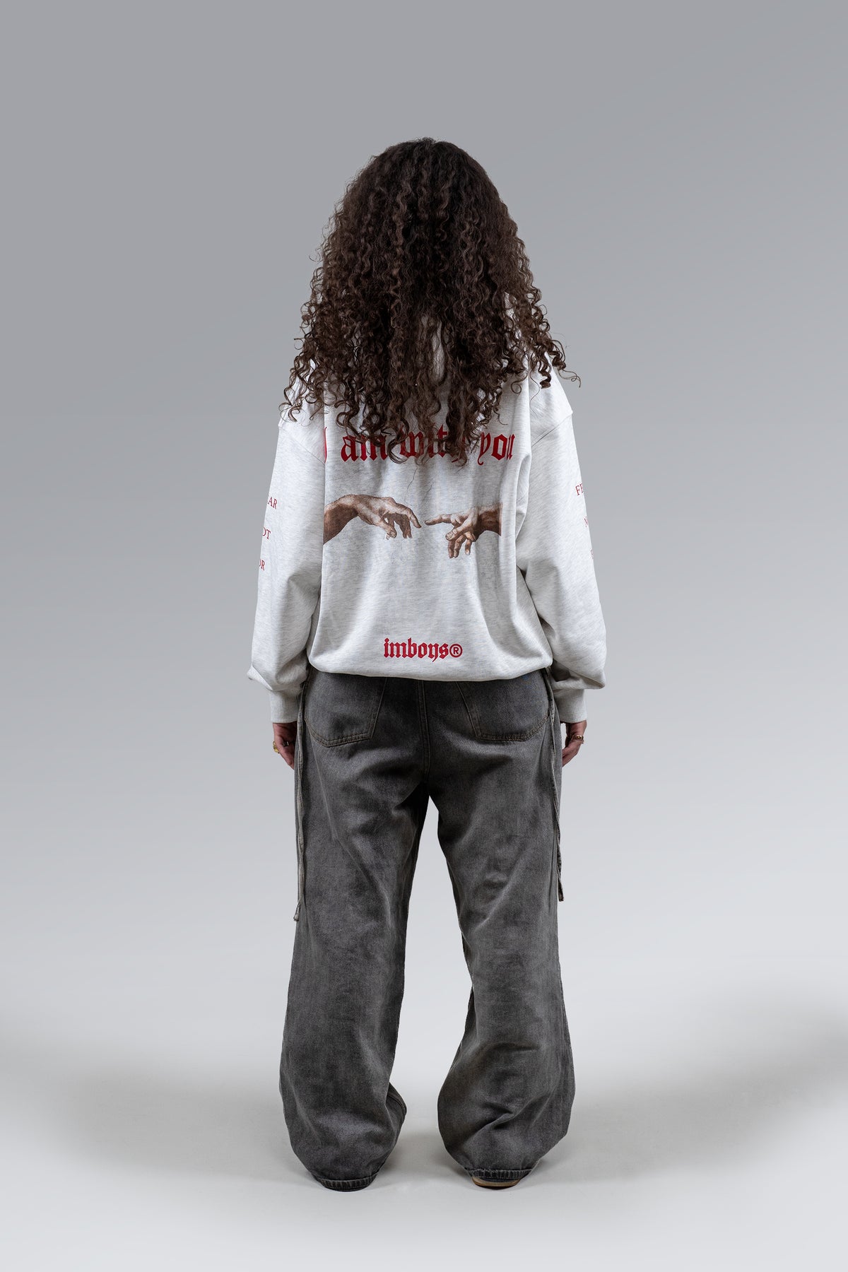 Female model wearing Grey Fear Not Hoodie, back view