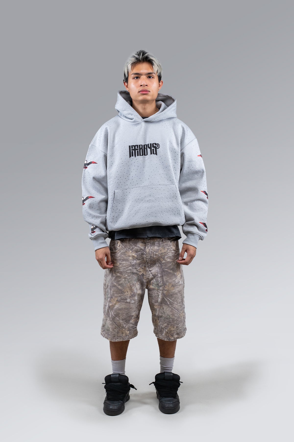 Male model wearing Redemption Rhinestone Hoodie Grey, front view