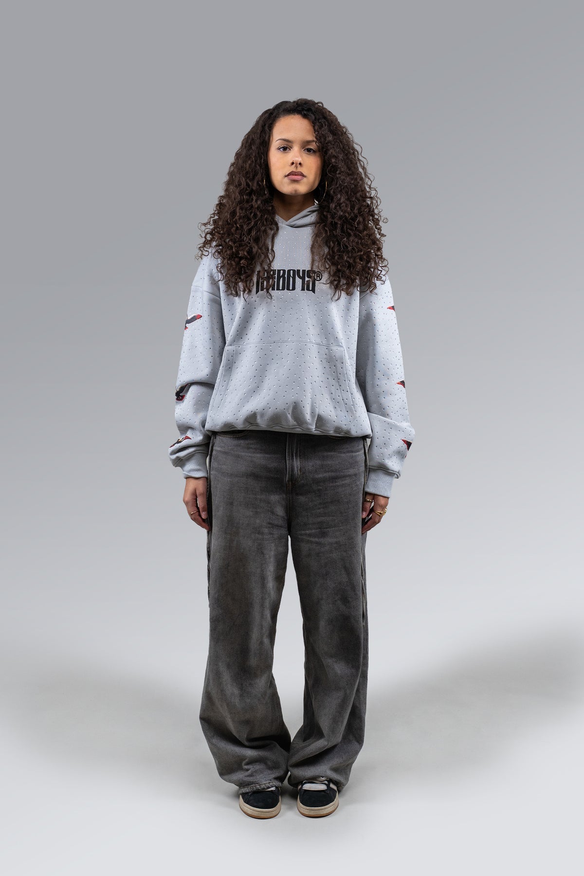 Female model wearing Redemption Rhinestone Hoodie Grey, front view